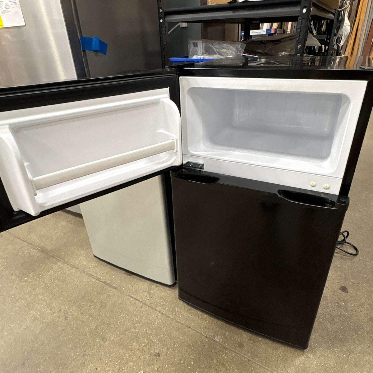 Criterion Mini Fridge Freezer - top freezer compartment open above the closed refrigerator door