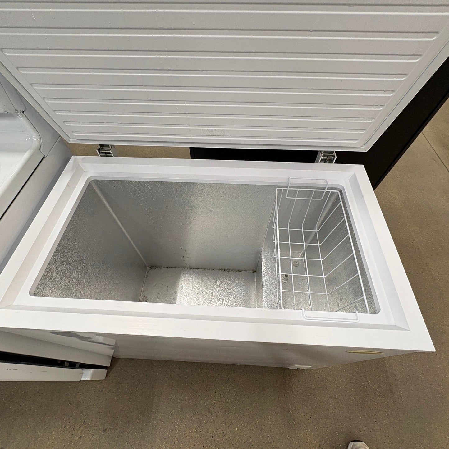 GDM Habitat for Humanity ReStore white chest freezer with open lid and interior storage basket