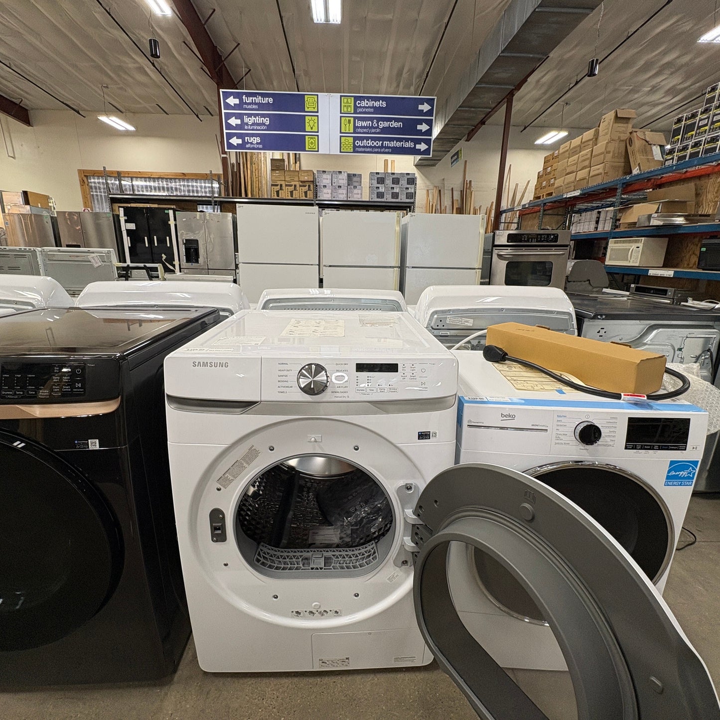 GDM Habitat for Humanity ReStore white Samsung front load washing machine with open door in a retail showroom