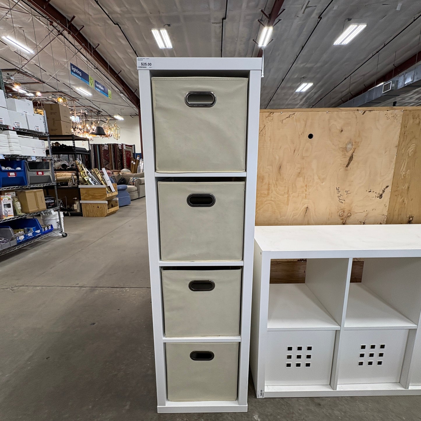 GDM Habitat for Humanity ReStore white four-tier vertical storage unit with beige fabric bins in a retail setting