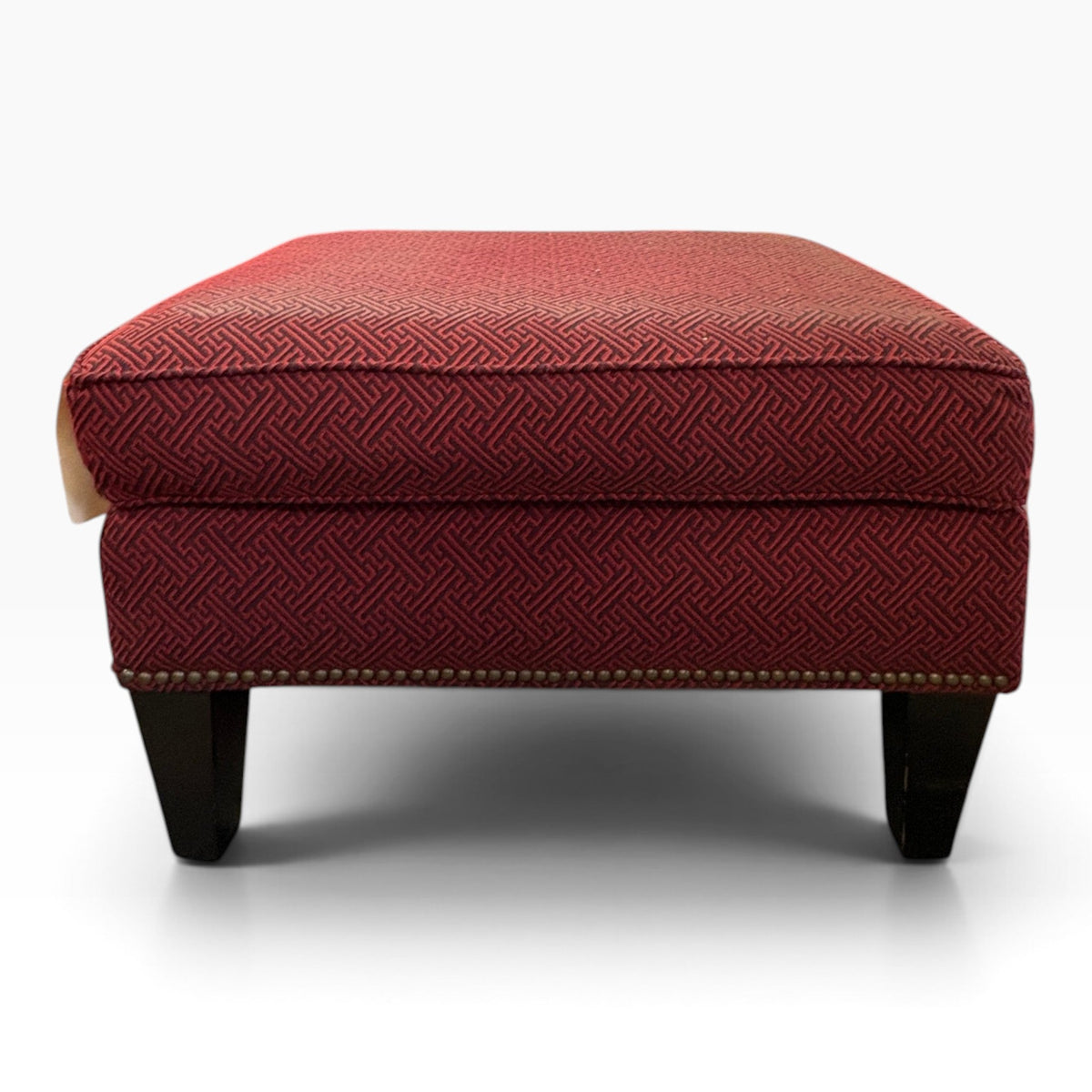 Burgundy Greek-Key Ottoman with Nailhead Trim at the Urbandale Habitat ReStore