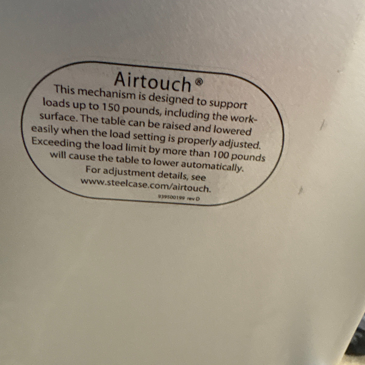 Steelcase Sit Stand Desk - Airtouch label under the top, rated to 150 pounds