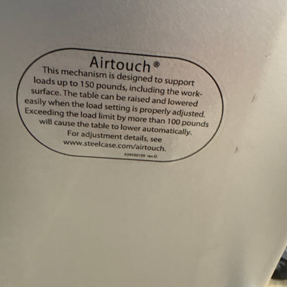 Steelcase Sit Stand Desk - Airtouch label under the top, rated to 150 pounds