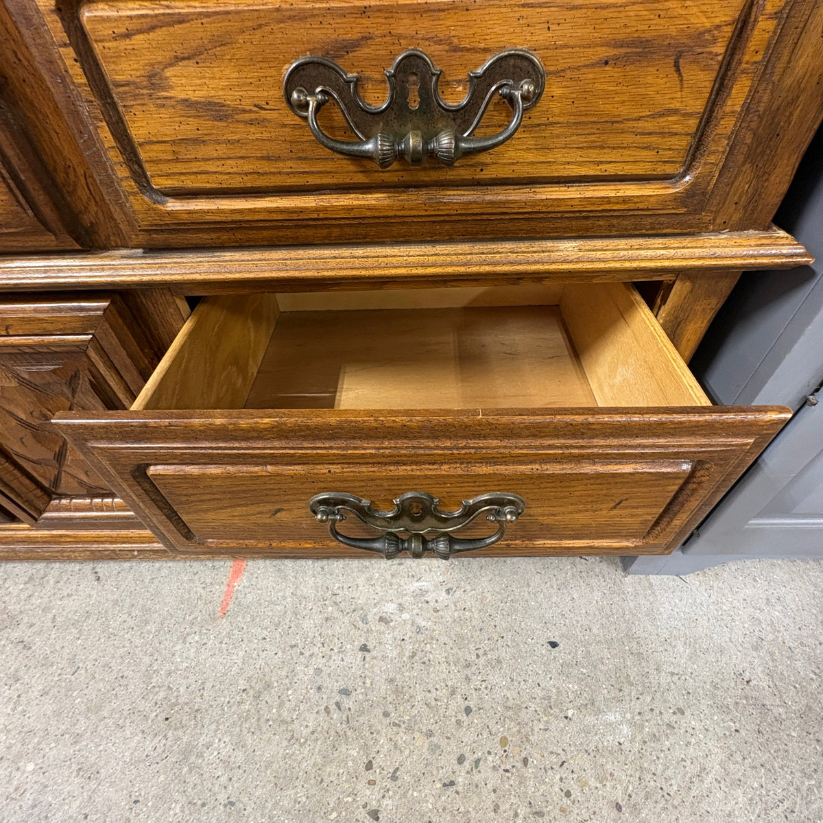 Oak Triple Dresser with Mirror - upper drawer open with brass batwing pulls