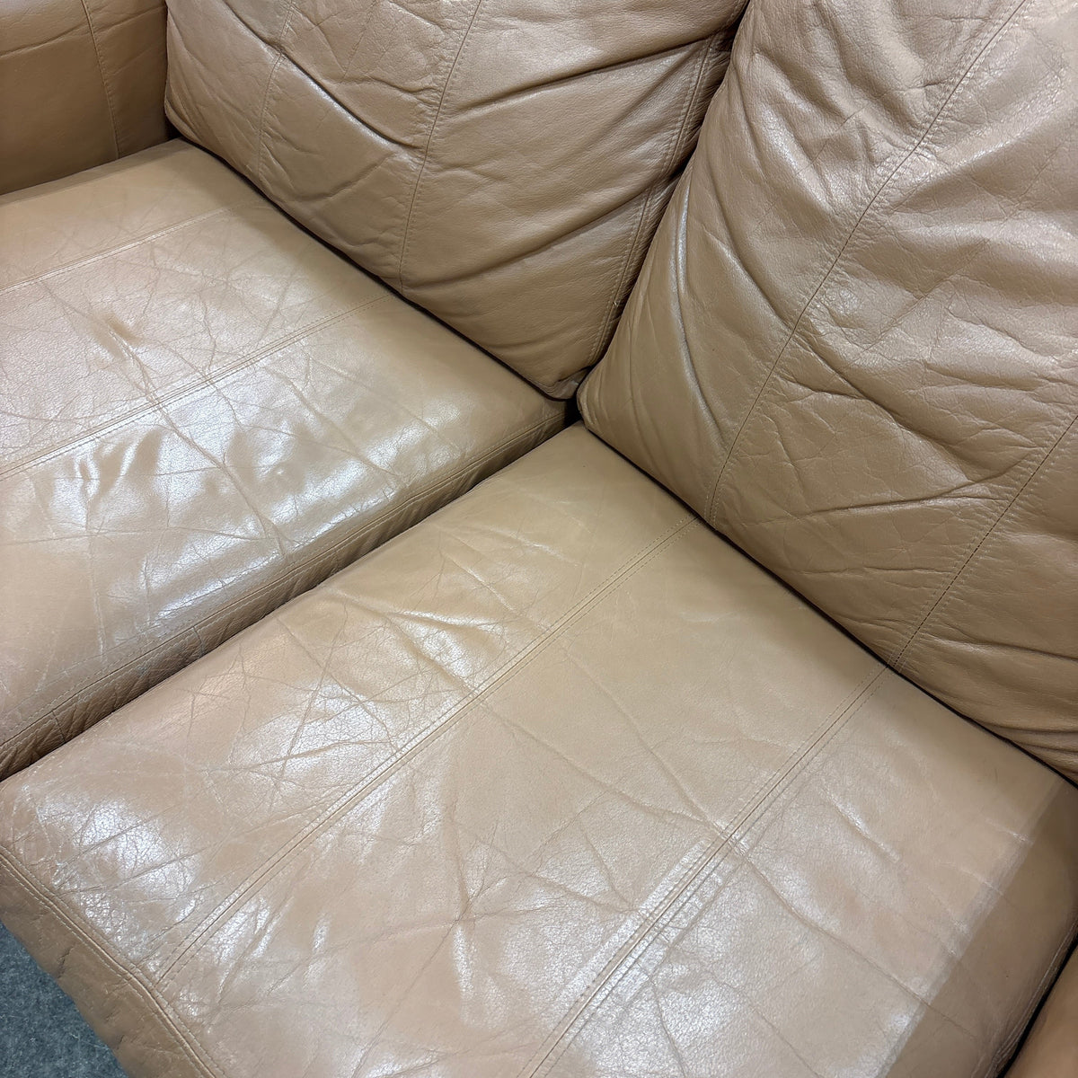 Tan Leather Loveseat - close-up of the leather seat and back cushions