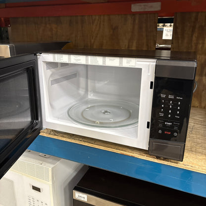 Frigidaire Blk SS Microwave - door open showing the white interior and glass turntable