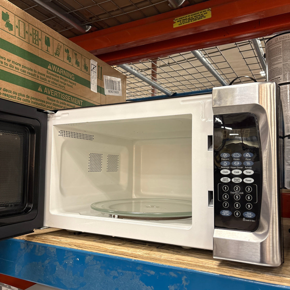 Oster Countertop Microwave - door open showing the white interior and glass turntable