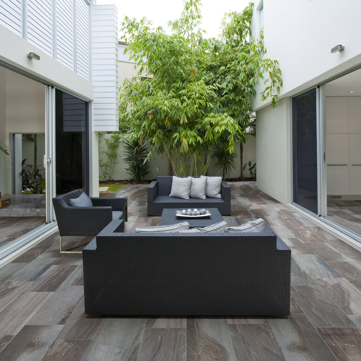 Fossil Smoke porcelain tile on an outdoor courtyard patio