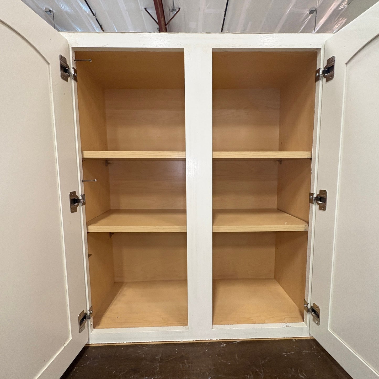 GDM Habitat for Humanity ReStore antique white kitchen cabinets with open doors and natural wood interior shelving