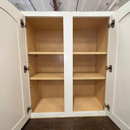 GDM Habitat for Humanity ReStore antique white kitchen cabinets with open doors and natural wood interior shelving