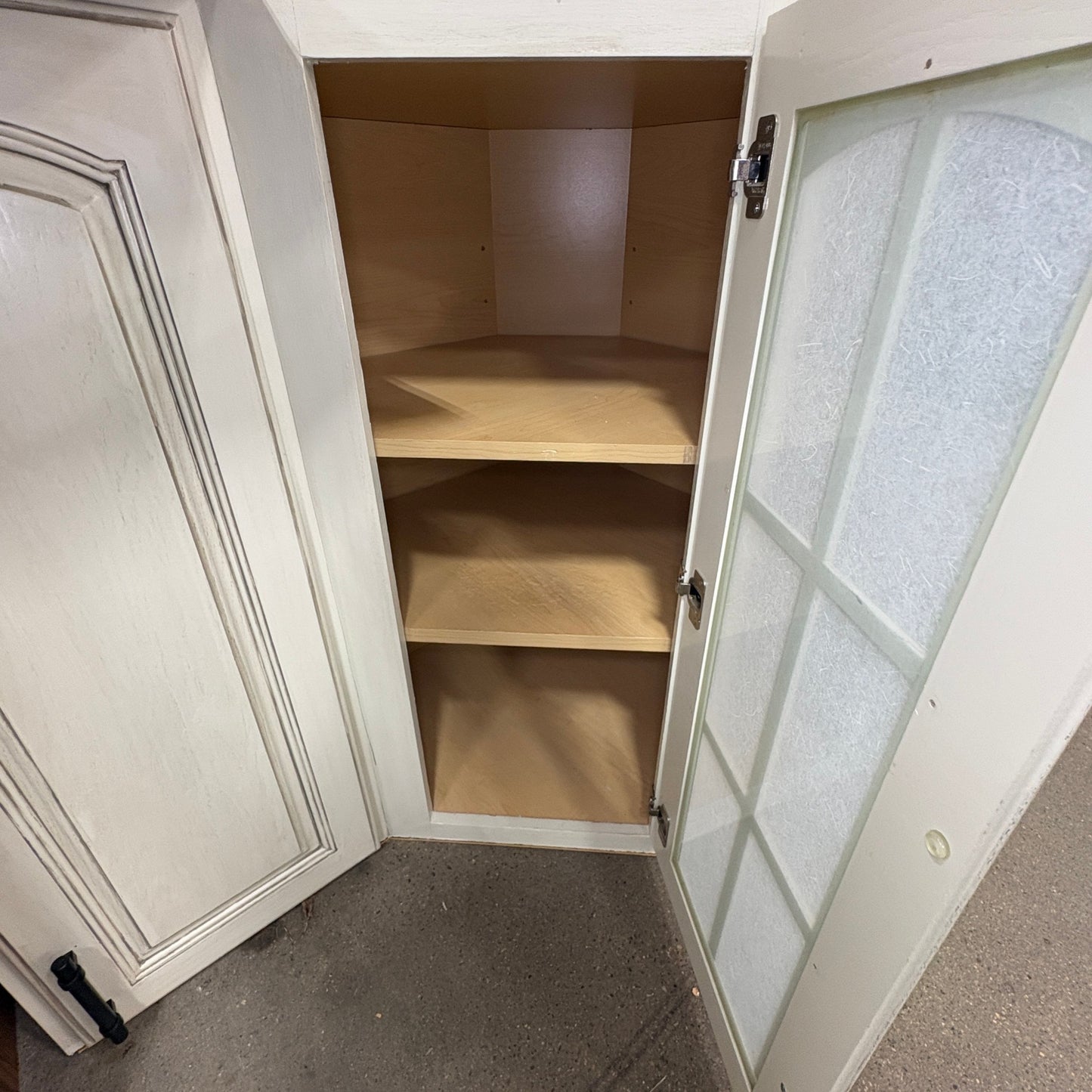 GDM Habitat for Humanity ReStore antique white corner cabinet with a glass panel door and natural wood interior shelves