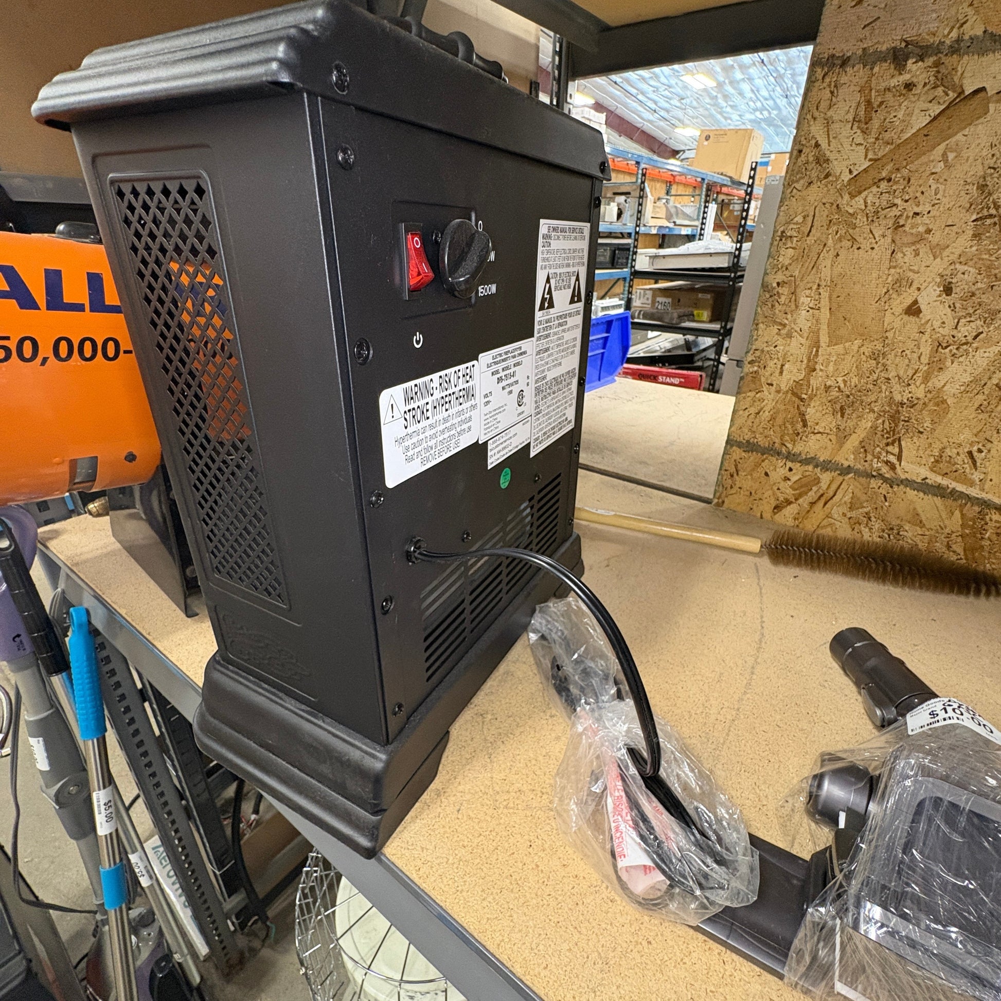 GDM Habitat for Humanity ReStore black electric space heater with power switch and cord on a workshop table