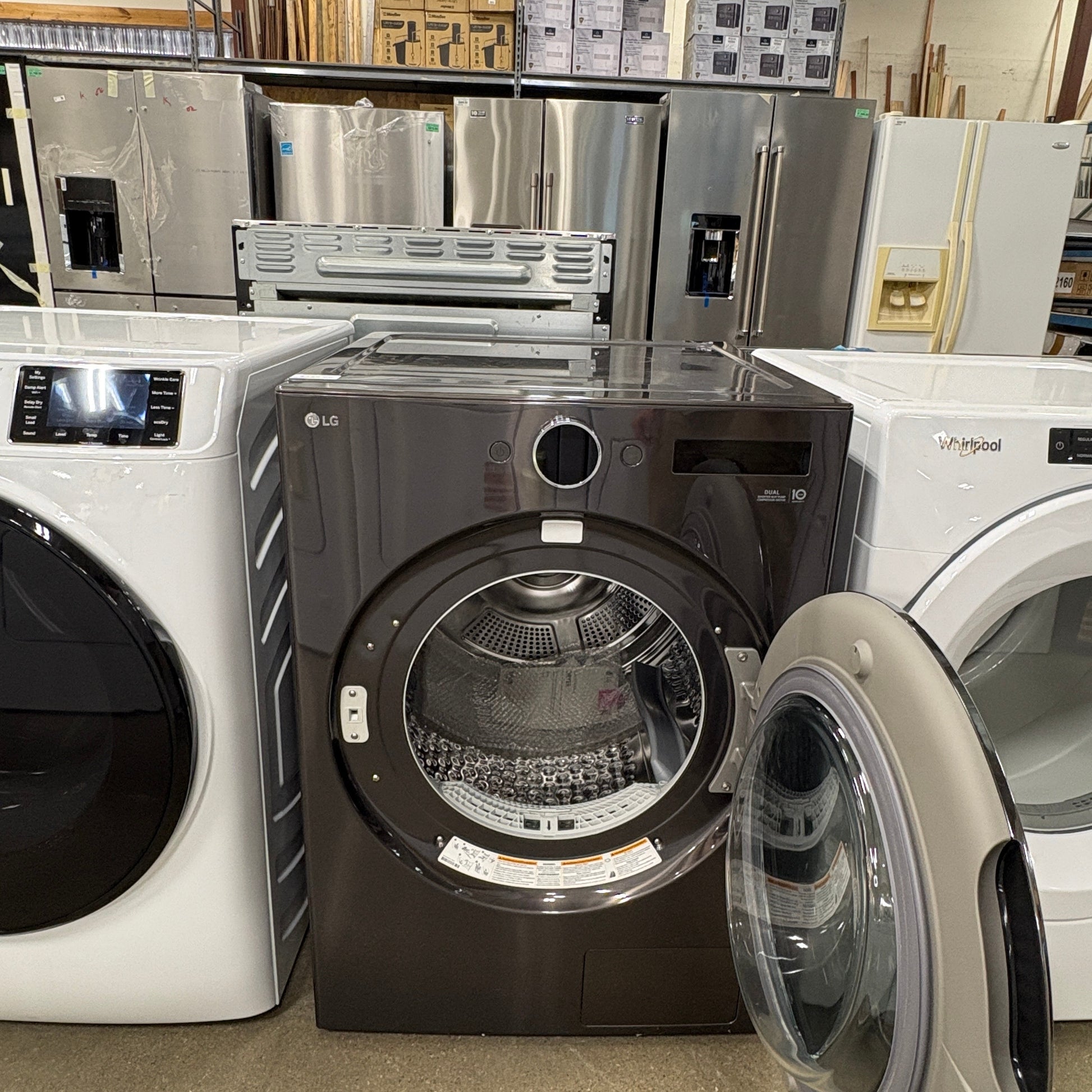 GDM Habitat for Humanity ReStore black LG front load dryer with open door in a warehouse appliance showroom