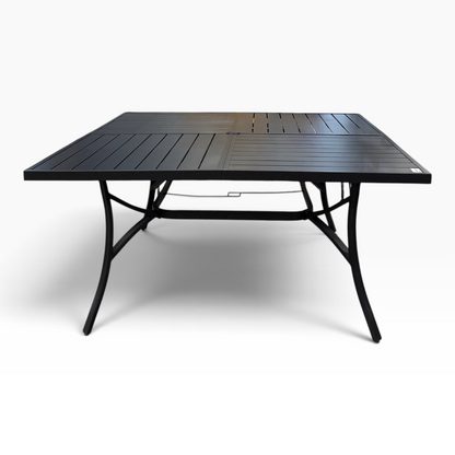 GDM Habitat for Humanity ReStore black metal patio dining table with a slatted top and curved legs in a retail store