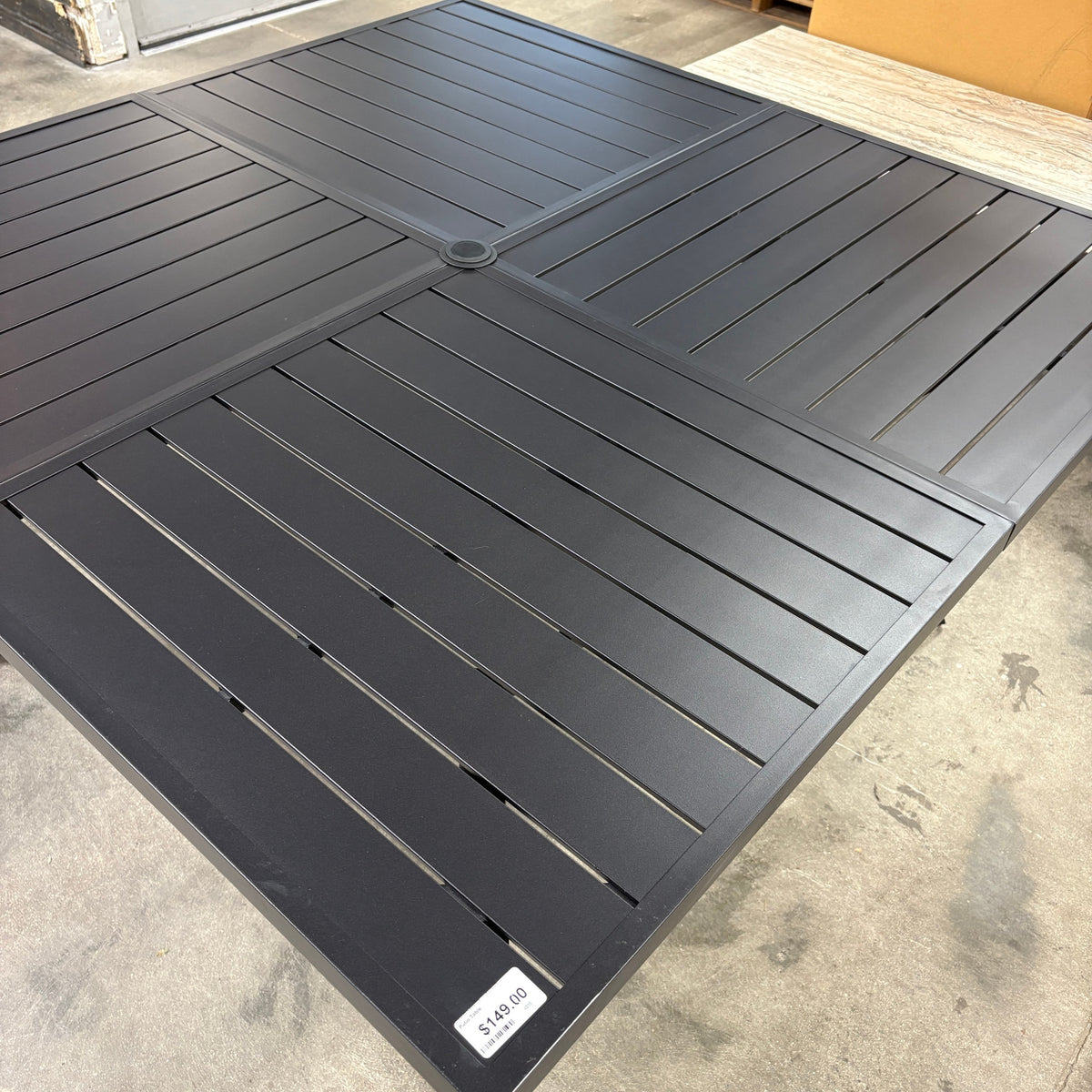 GDM Habitat for Humanity ReStore square black metal patio dining table with a slatted surface design