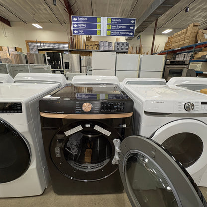 GDM Habitat for Humanity ReStore display featuring a black Samsung front-load dryer with an open door