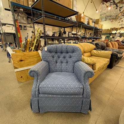 GDM Habitat for Humanity ReStore blue patterned fabric armchair with tufted back and skirted base in a warehouse