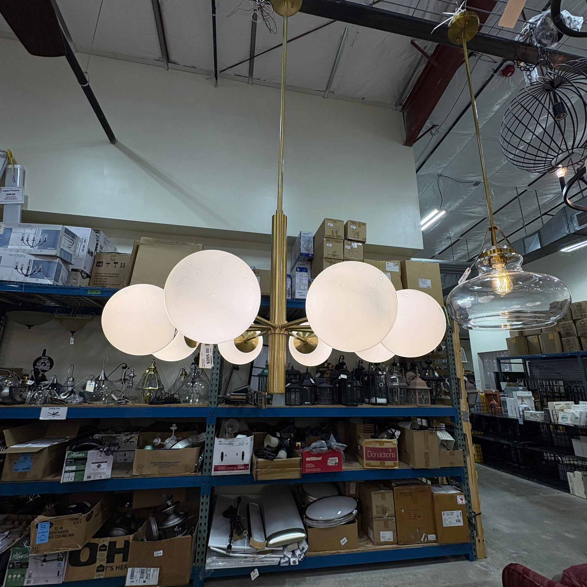 GDM Habitat for Humanity ReStore modern brass chandelier with multiple spherical white glass globes in a warehouse