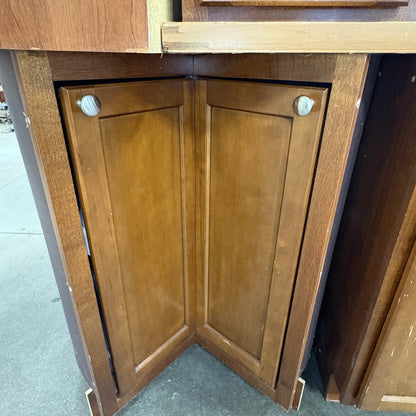 GDM Habitat for Humanity ReStore brown wooden corner kitchen cabinet with shaker style doors and silver knobs