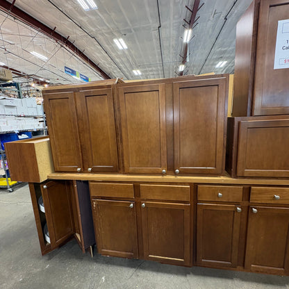 GDM Habitat for Humanity ReStore 13-piece brown wooden kitchen cabinet set with shaker-style doors and silver knobs.