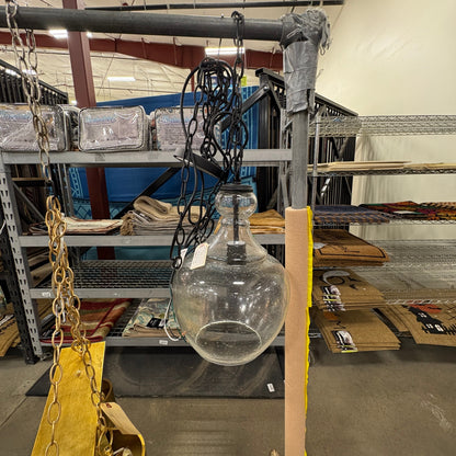 GDM Habitat for Humanity ReStore clear glass pendant light fixture with a black chain hanging in a retail store