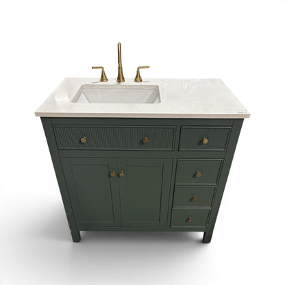 GDM Habitat for Humanity ReStore dark green fluted bathroom vanity with white stone countertop and brass hardware