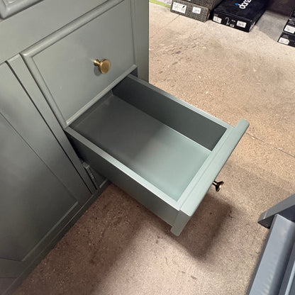 GDM Habitat for Humanity ReStore dark green bathroom vanity with an open drawer and round brass hardware