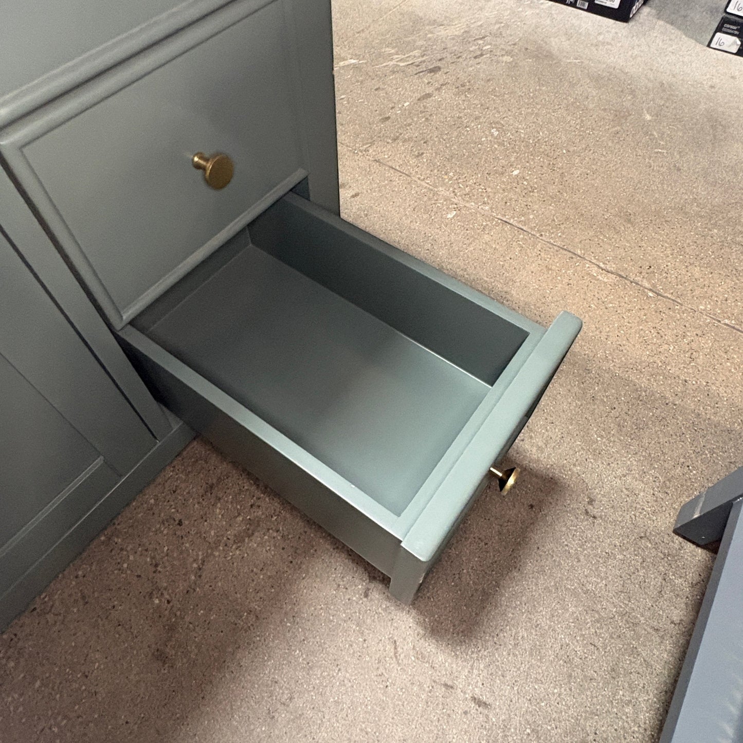 GDM Habitat for Humanity ReStore dark green vanity with a single open drawer featuring a round brass knob.