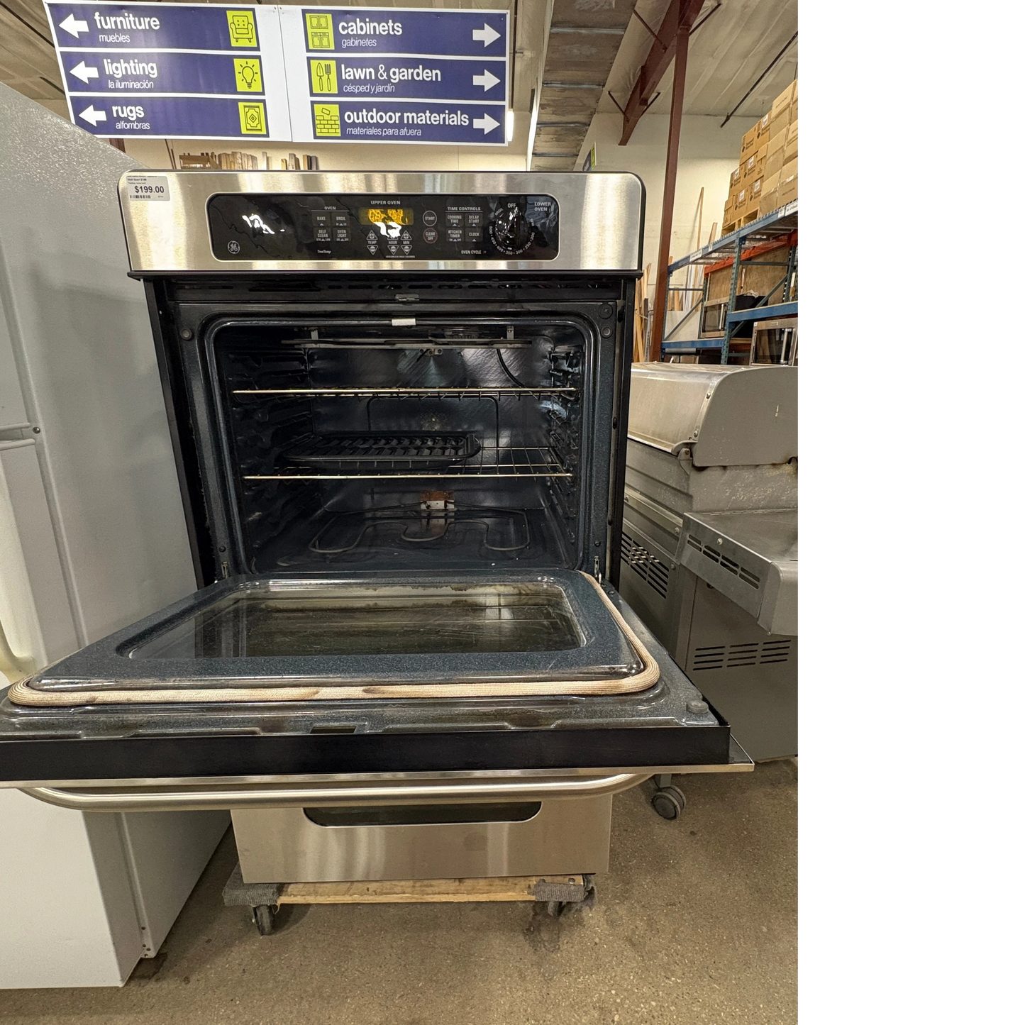 GDM Habitat for Humanity ReStore stainless steel GE electric wall oven with open door in a retail warehouse setting
