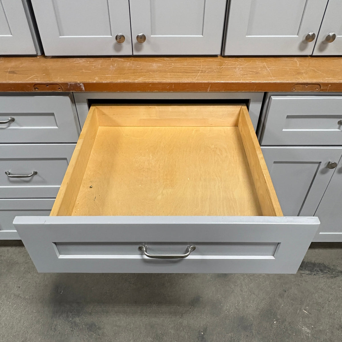 GDM Habitat for Humanity ReStore 15 pc gray cabinet set with an open wooden drawer and silver metal handles