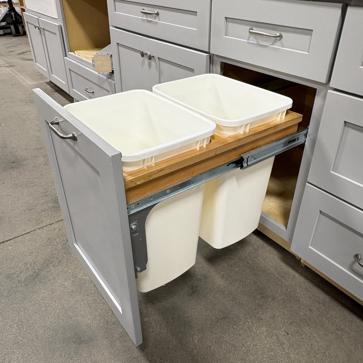 GDM Habitat for Humanity ReStore gray kitchen cabinet with a pull-out double trash bin insert on wooden rails