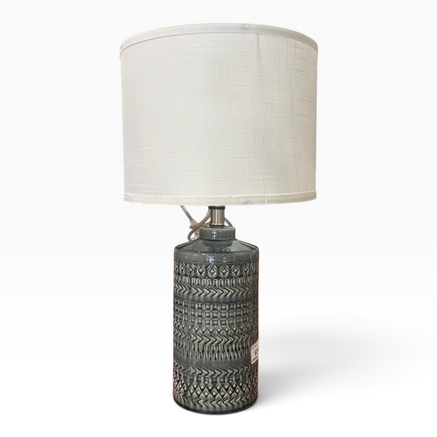 GDM Habitat for Humanity ReStore gray ceramic table lamp with a textured geometric pattern and a white fabric shade.