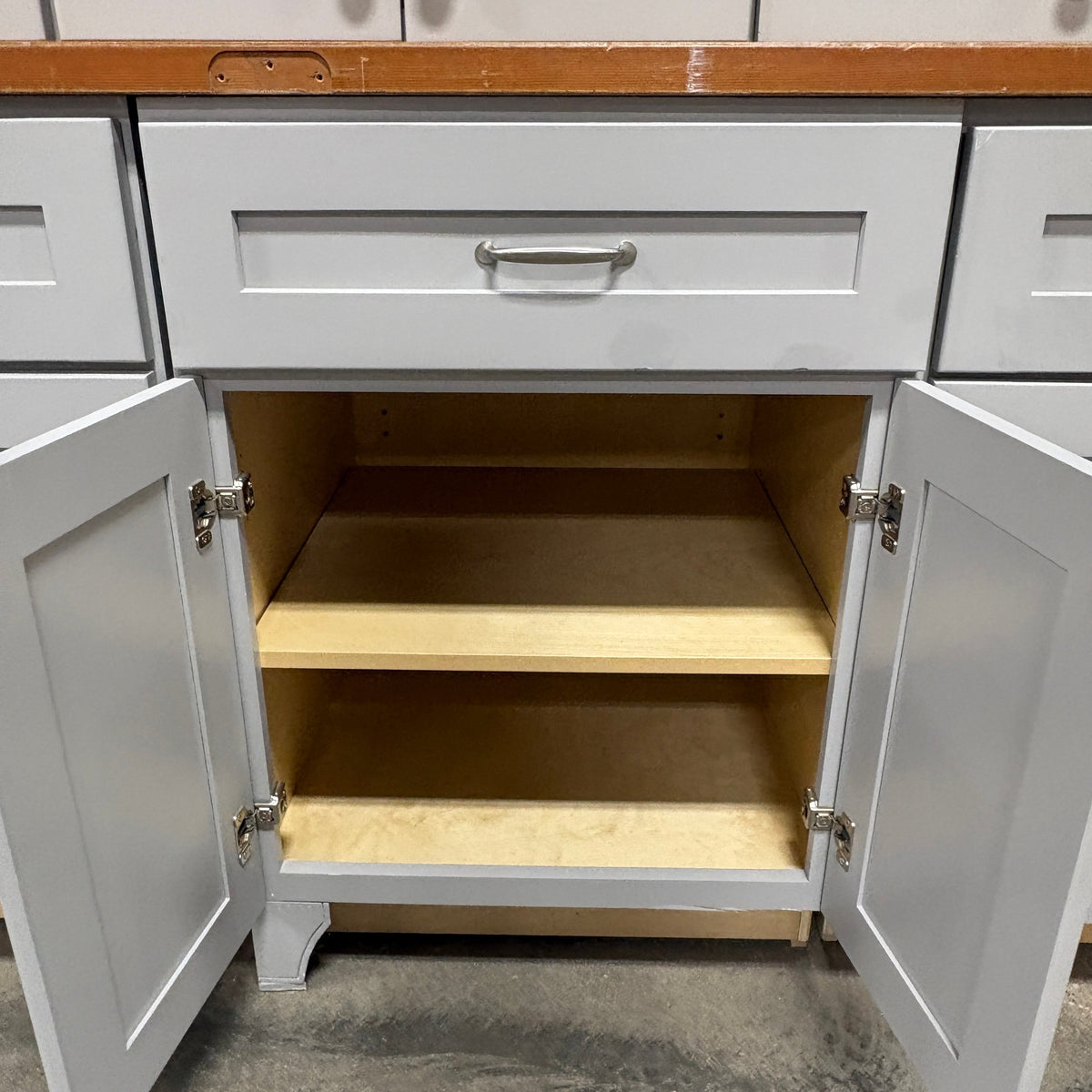 GDM Habitat for Humanity ReStore gray shaker style kitchen cabinet with open doors and internal shelving