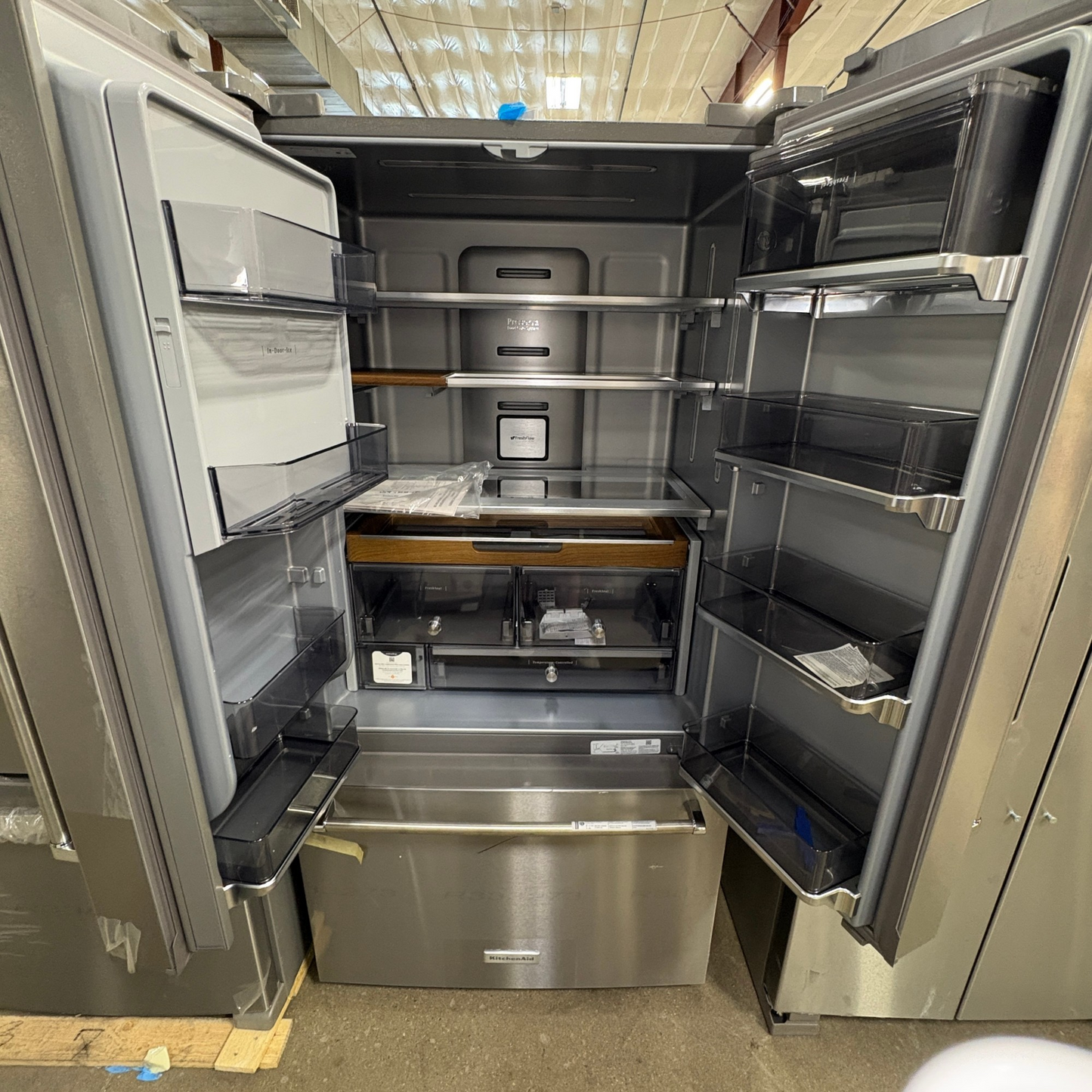 GDM Habitat for Humanity ReStore KitchenAid French door refrigerator with open doors showing interior shelves