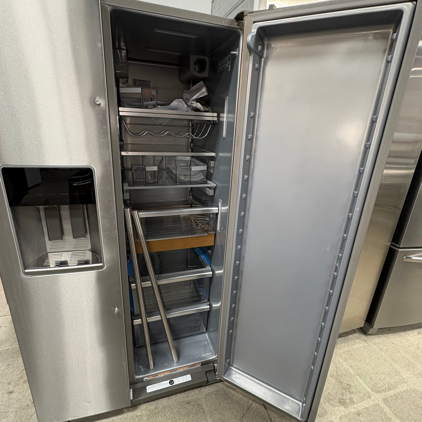 GDM Habitat for Humanity ReStore KitchenAid stainless steel side-by-side refrigerator with open door and ice dispenser