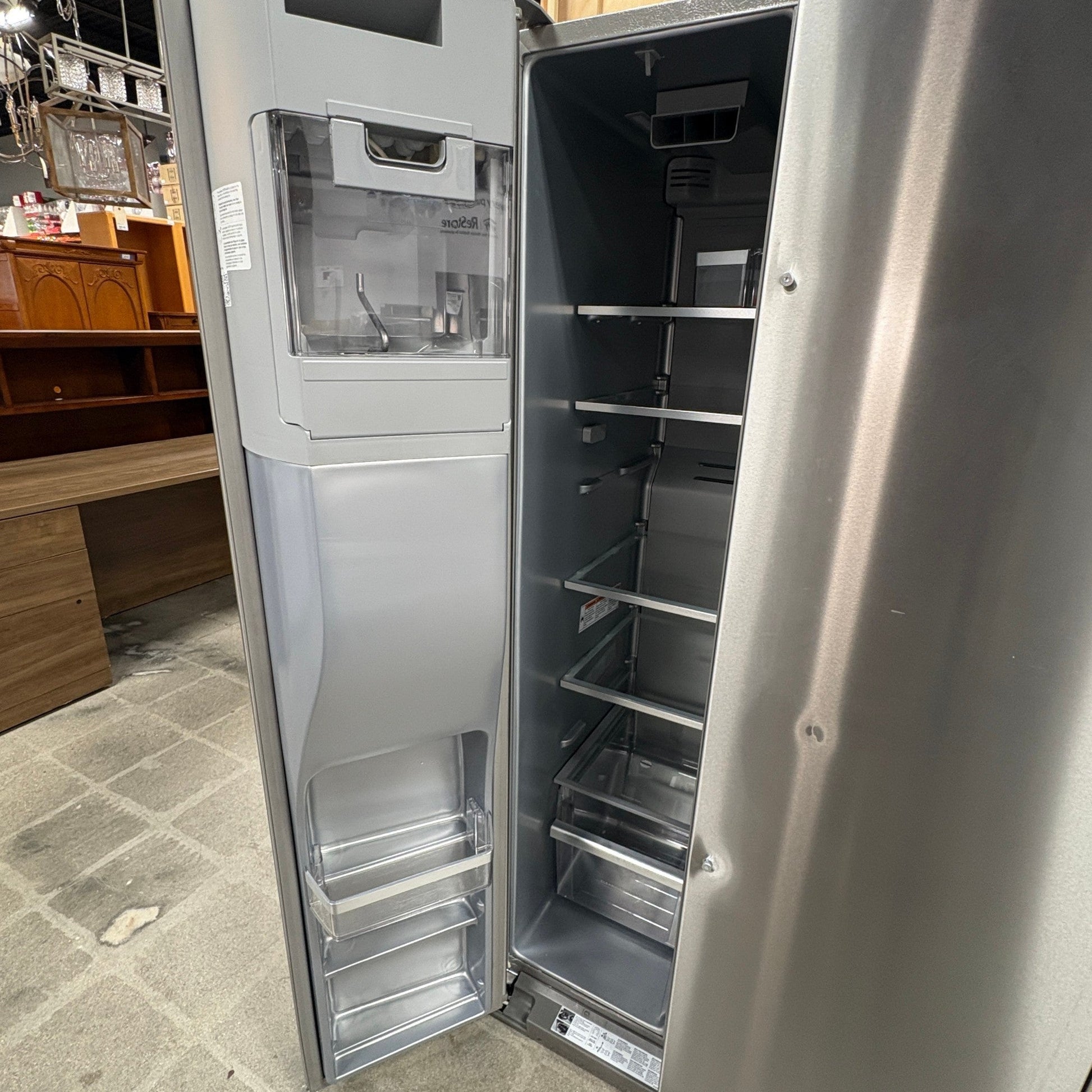 GDM Habitat for Humanity ReStore KitchenAid side-by-side refrigerator with open door showing interior shelving