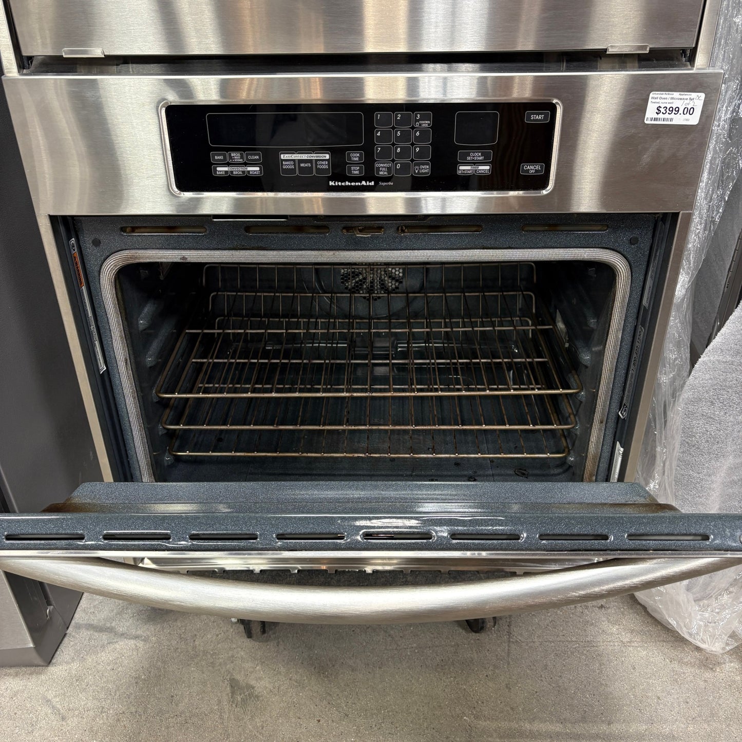 GDM Habitat for Humanity ReStore KitchenAid stainless steel built-in wall oven with open door and interior racks