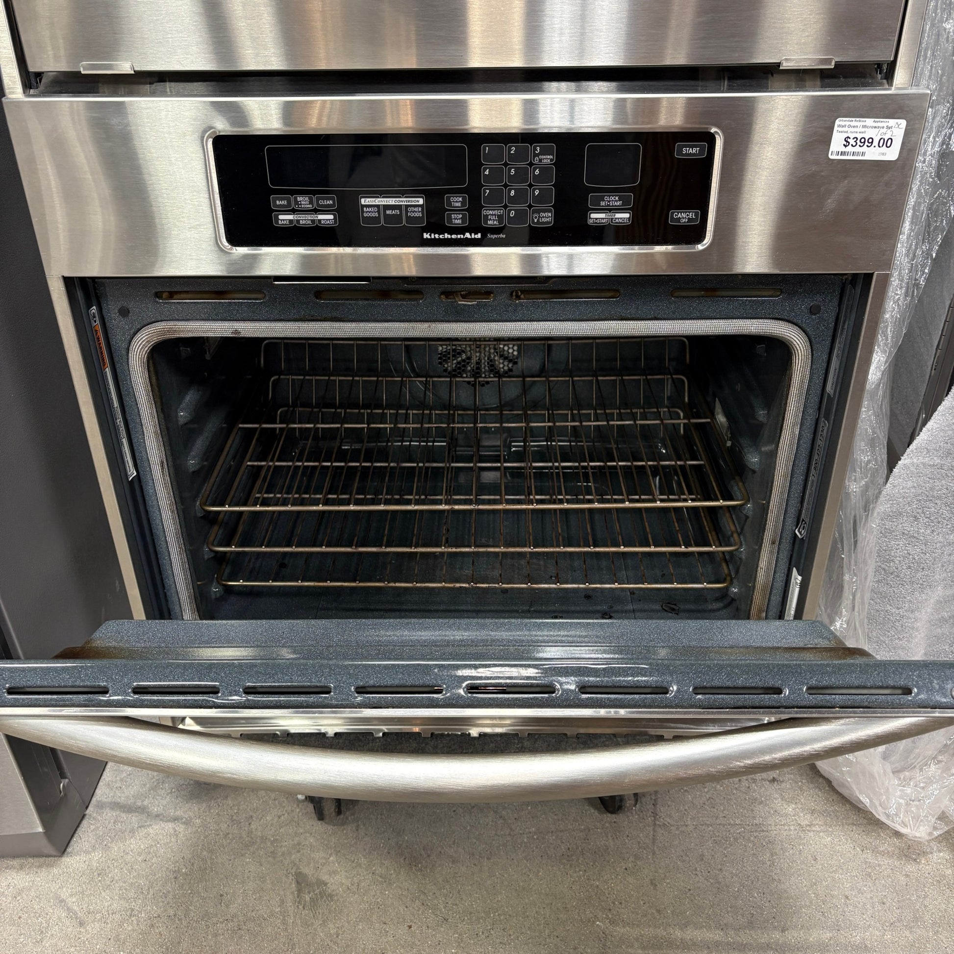 GDM Habitat for Humanity ReStore KitchenAid stainless steel built-in wall oven with open door and interior racks