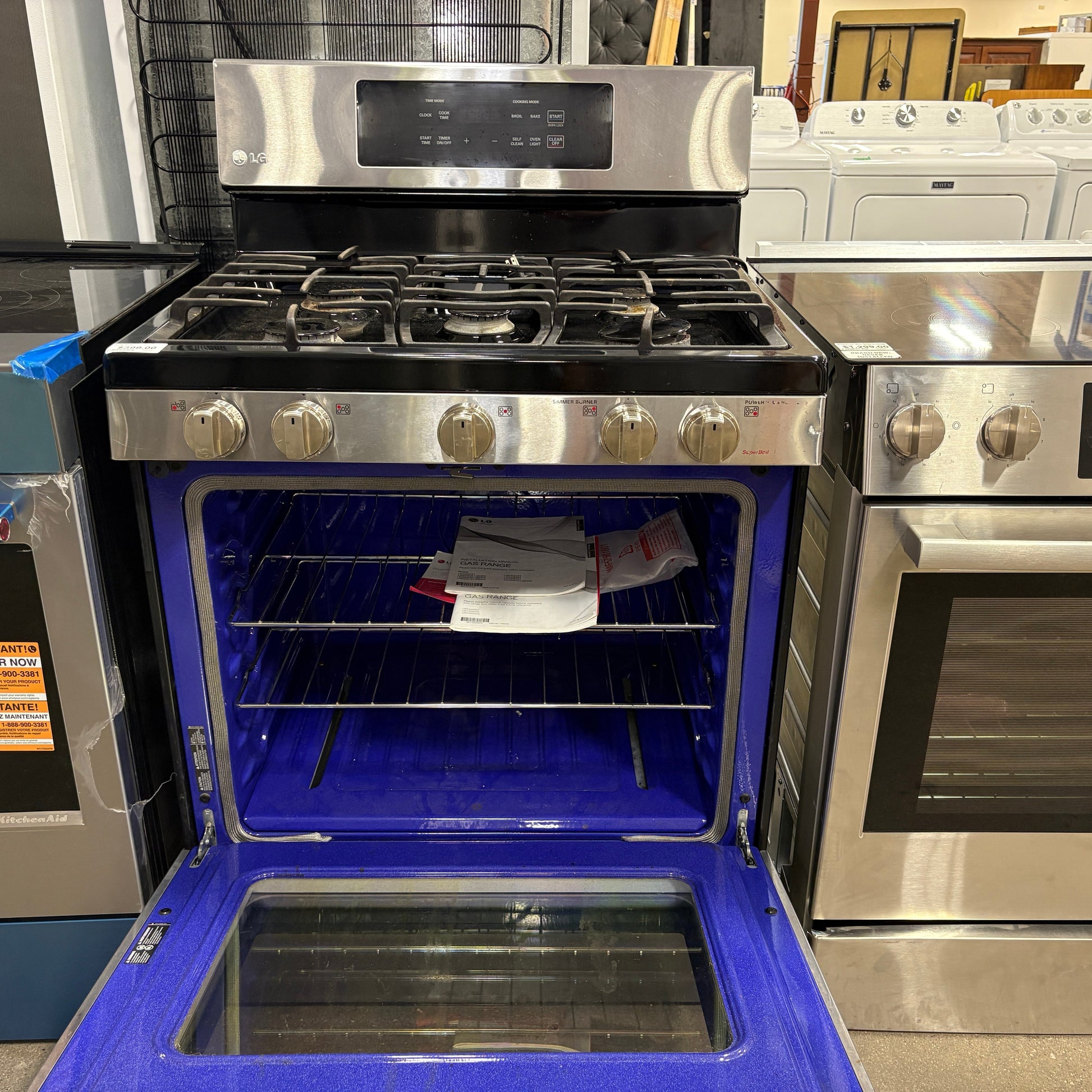 GDM Habitat for Humanity ReStore stainless steel LG gas range with open oven door and blue interior