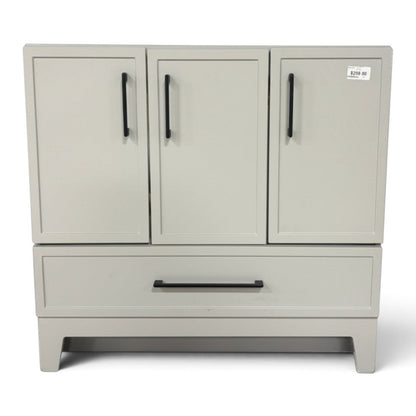 GDM Habitat for Humanity ReStore 36-inch light gray bathroom vanity base with shaker doors and black bar pulls.