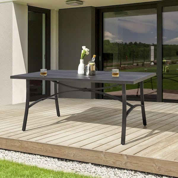 GDM Habitat for Humanity ReStore NUU Garden patio table with a dark grey slatted top on a wooden deck.