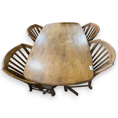 GDM Habitat for Humanity ReStore oak dining table with four matching spindle-back chairs in a natural wood finish.