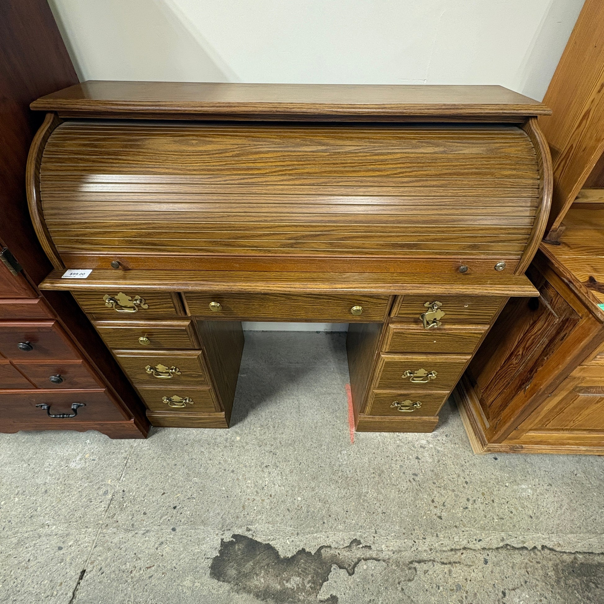 GDM Habitat for Humanity ReStore oak roll-top desk with multiple drawers and brass hardware in a vintage style