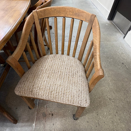GDM Habitat for Humanity ReStore oak dining chair with a spindle back and a textured beige upholstered seat.