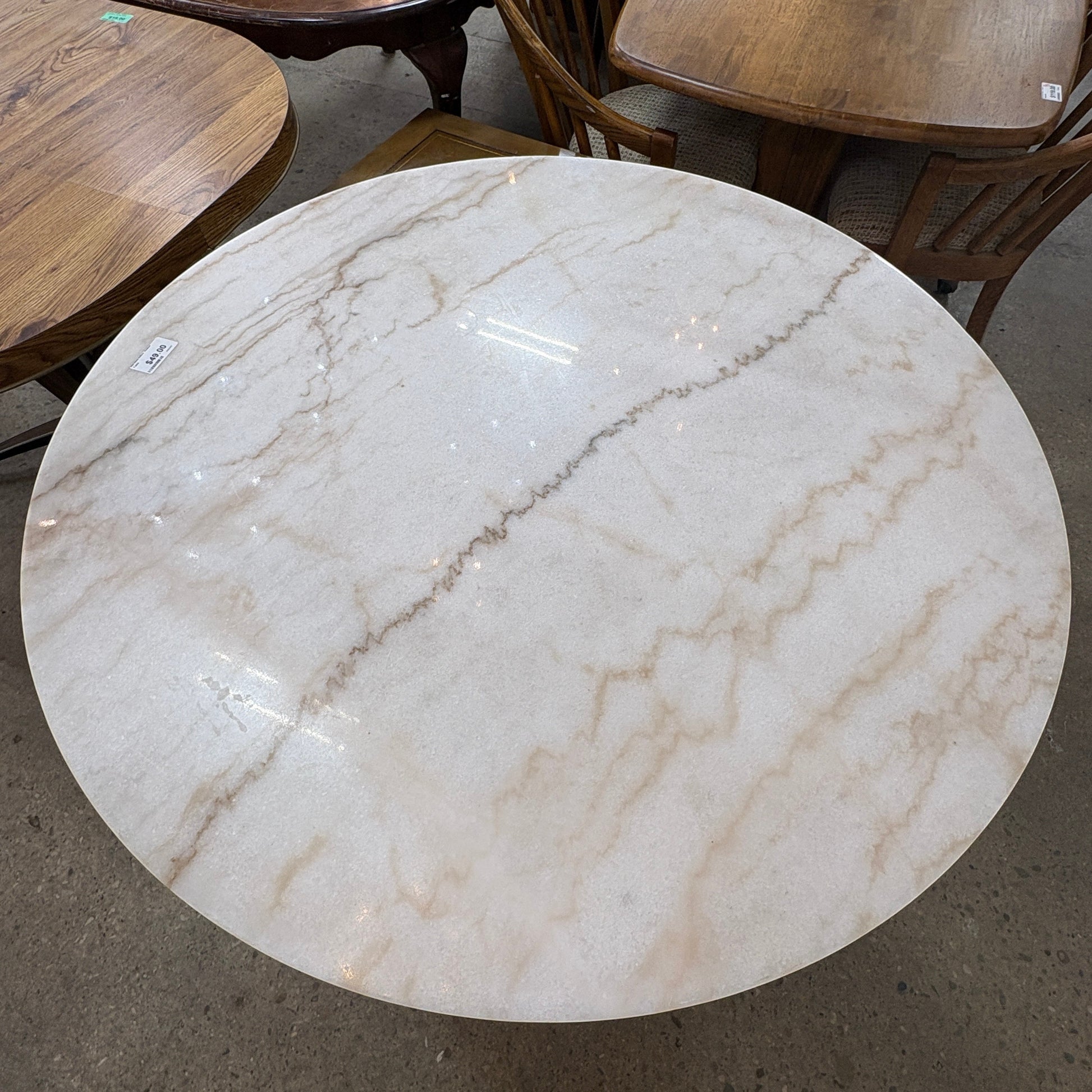 GDM Habitat for Humanity ReStore round table with a cream and brown marble-look finish and smooth surface