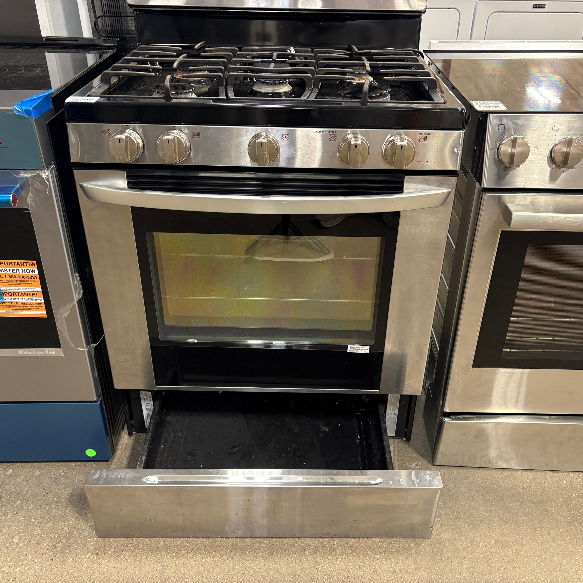 GDM Habitat for Humanity ReStore stainless steel gas range with black stovetop and open bottom storage drawer
