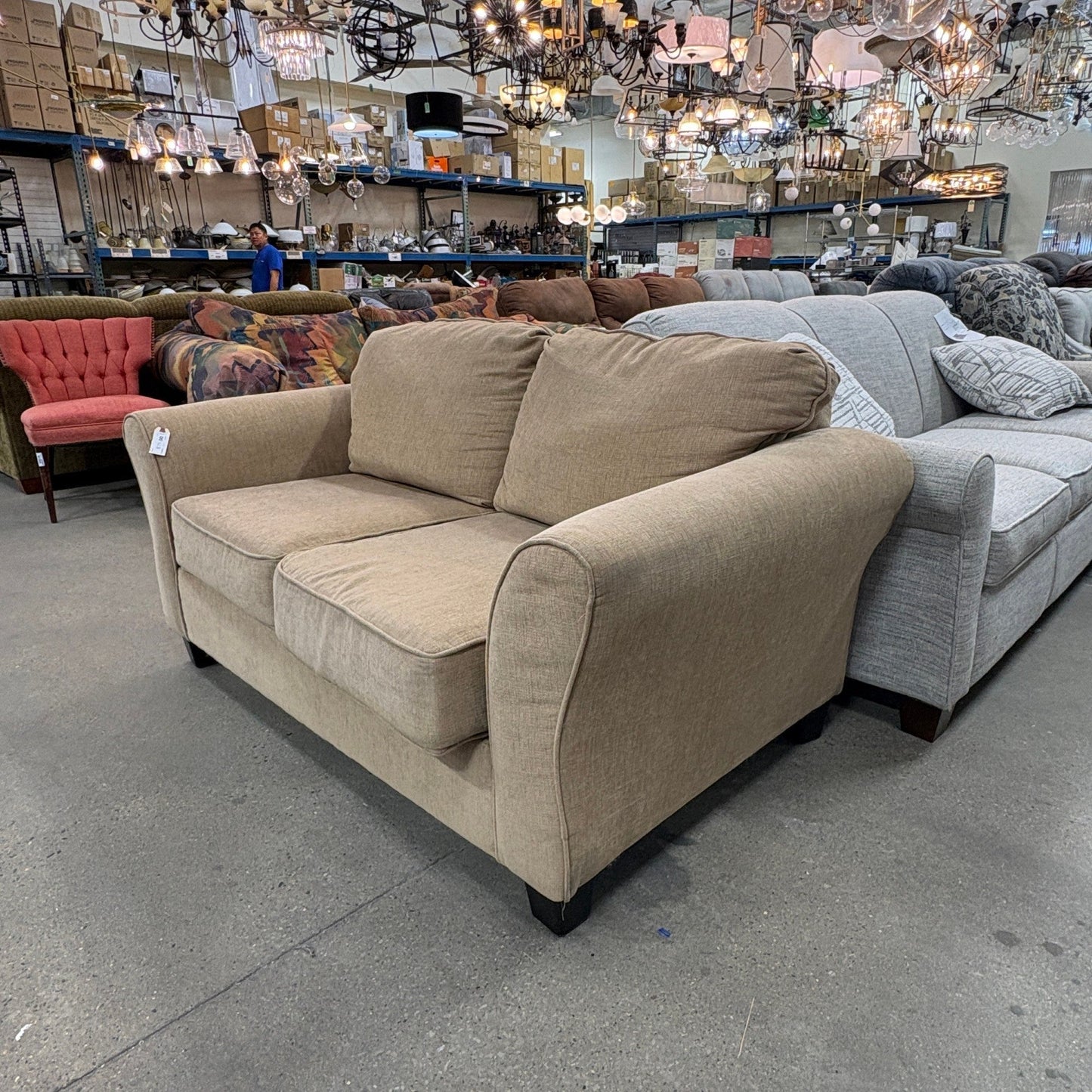 GDM Habitat for Humanity ReStore tan chenille loveseat with plush cushions in a retail furniture showroom setting