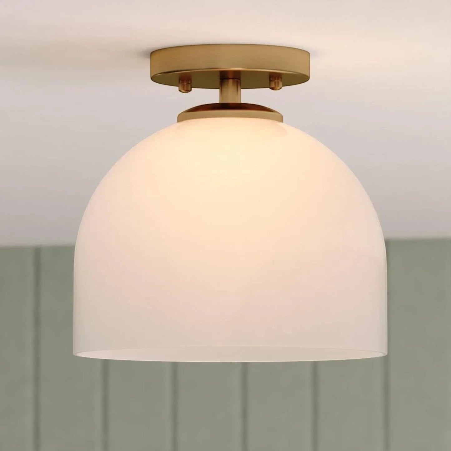 GDM Habitat for Humanity ReStore Vaxcel Shelby ceiling light with a brass finish and a white glass dome shade.