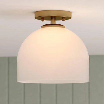 GDM Habitat for Humanity ReStore Vaxcel Shelby ceiling light with a brass finish and a white glass dome shade.