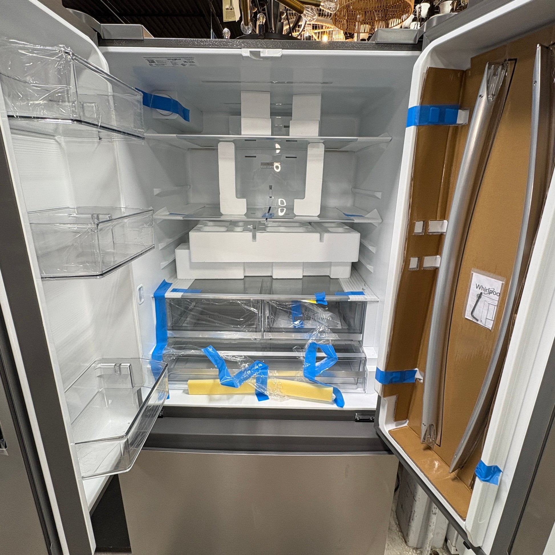 GDM Habitat for Humanity ReStore Whirlpool French door refrigerator interior with protective packaging and shelving
